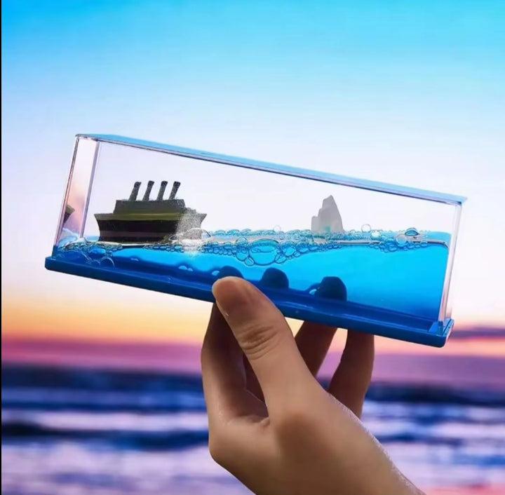 Mini Ocean Wave Desk Toy on desk with watch